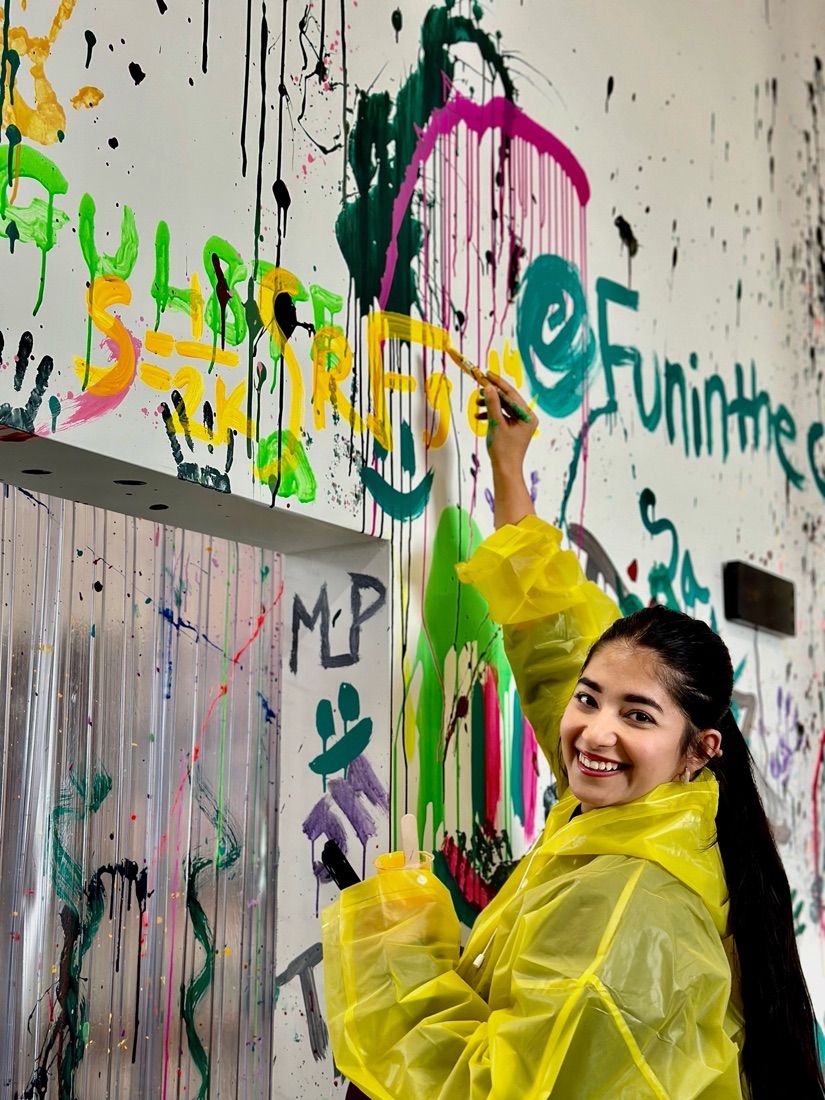 Prachi painting the gravitational action on a colorful wall
