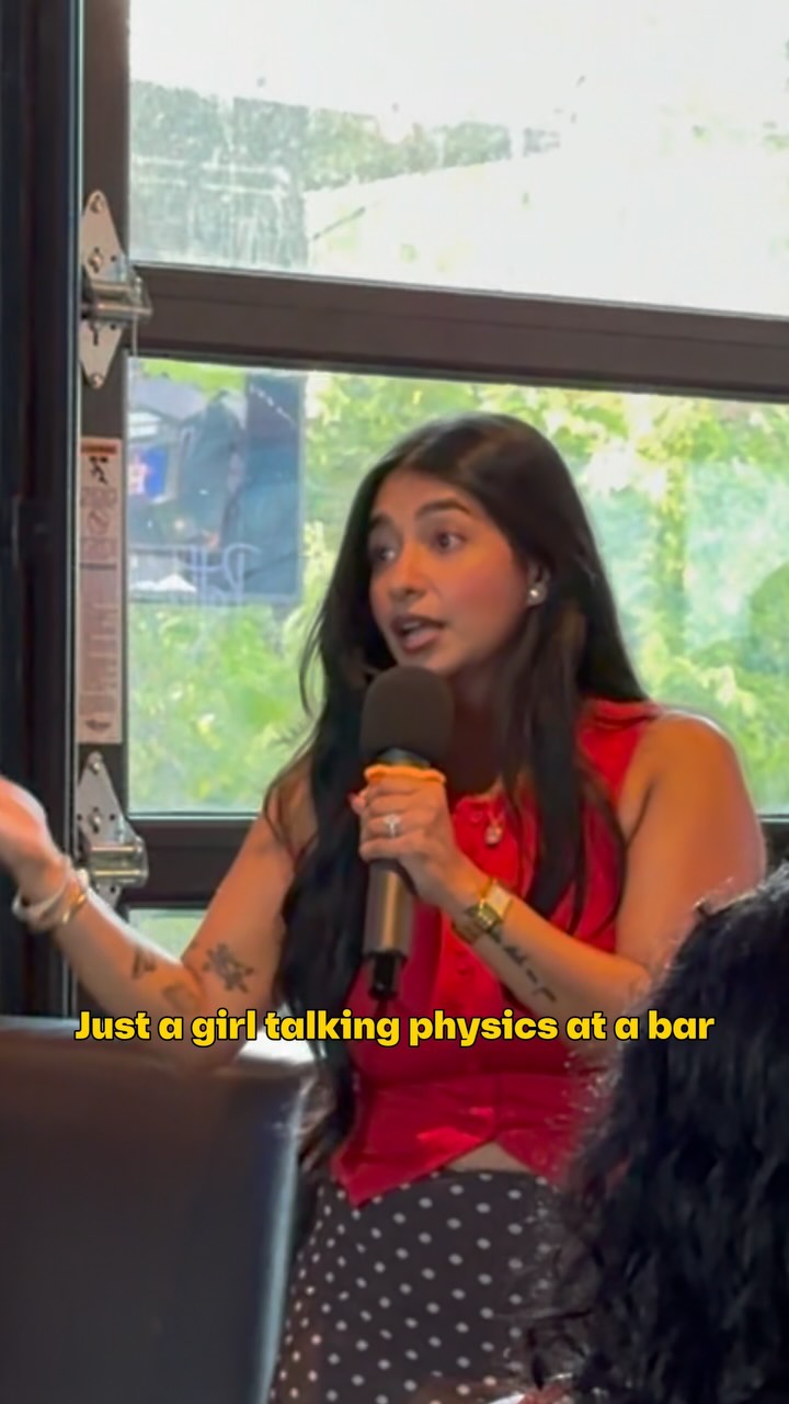 Prachi speaking into a microphone during an After5 Society public talk